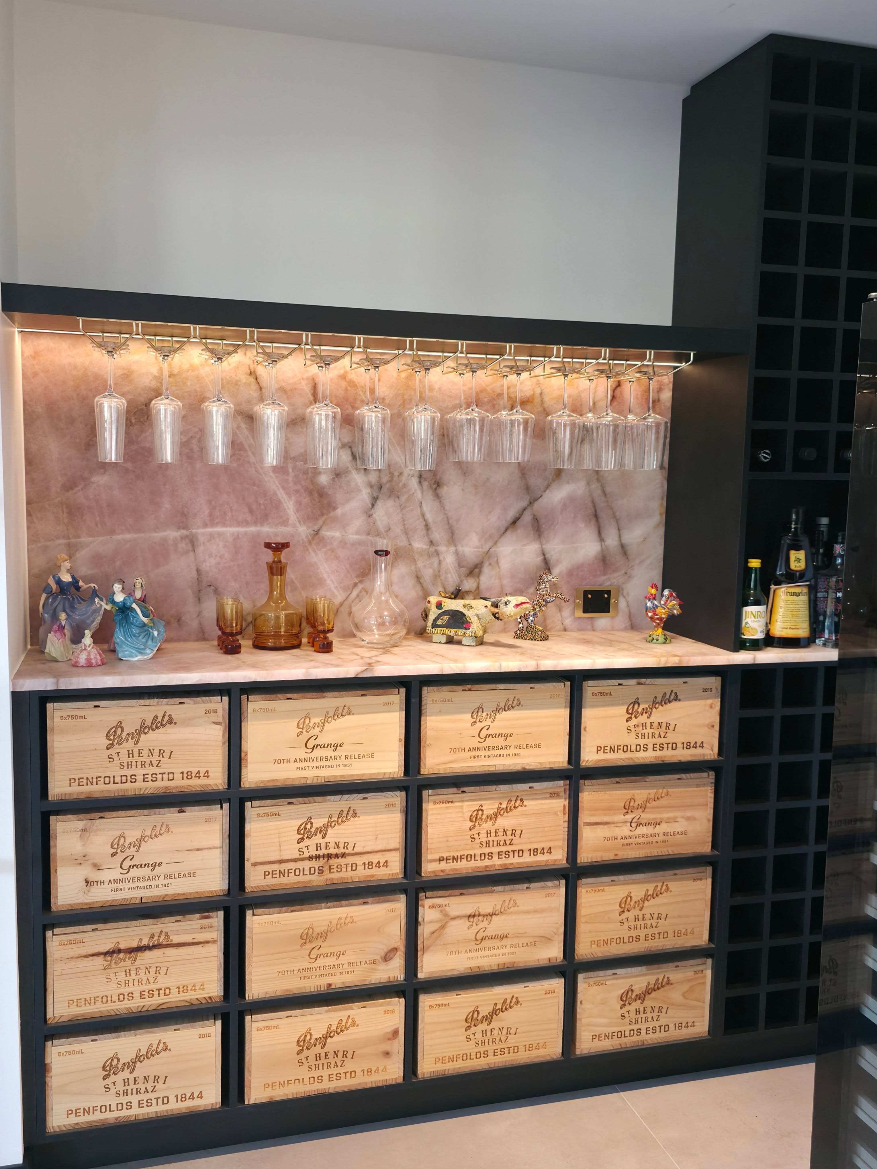 Custom bar with stone back panel and wine-crate drawers