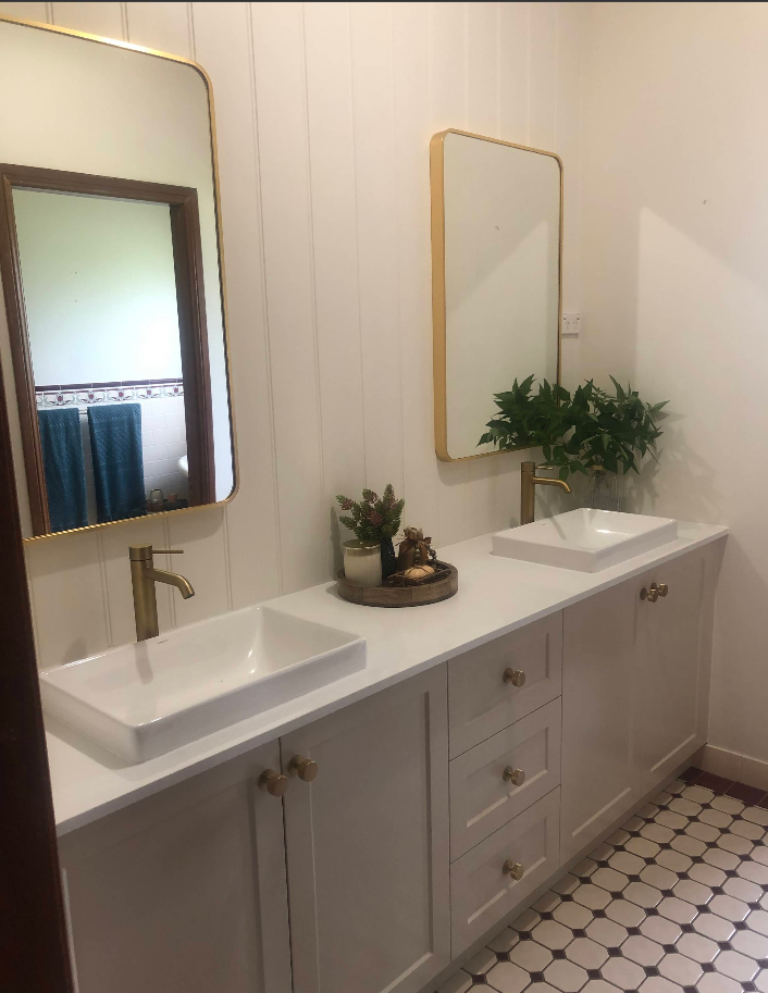 Custom double bathroom vanity with brass mirrors
