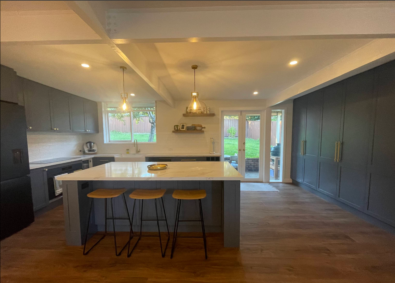Dark timber kitchen with large stone island
