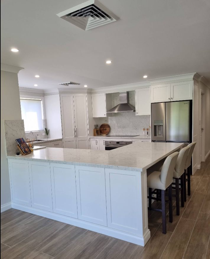 White kitchen with island and bar seating