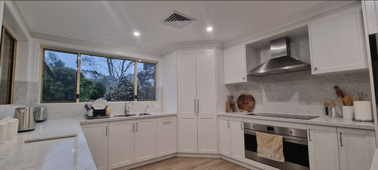 Bright white shaker kitchen with garden view